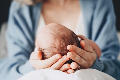 A mother holding her baby