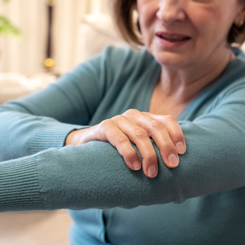 woman holding arm