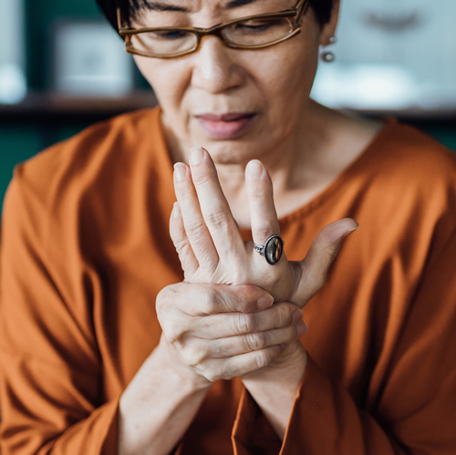 lady holding hand in pain