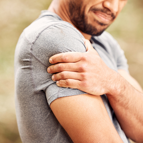 man holding shoulder in pain