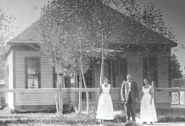 Three people standing in front of first hospital in Bend, OR