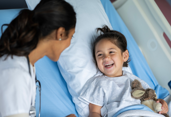 health care professional speaking to pediatric patient