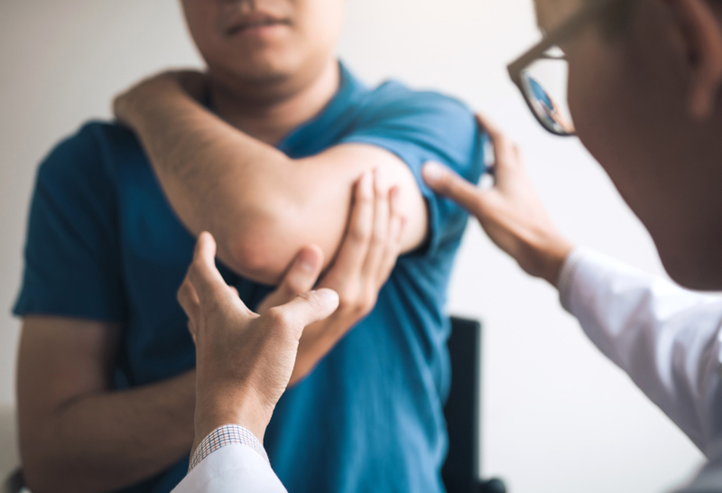 patient getting elbow examined