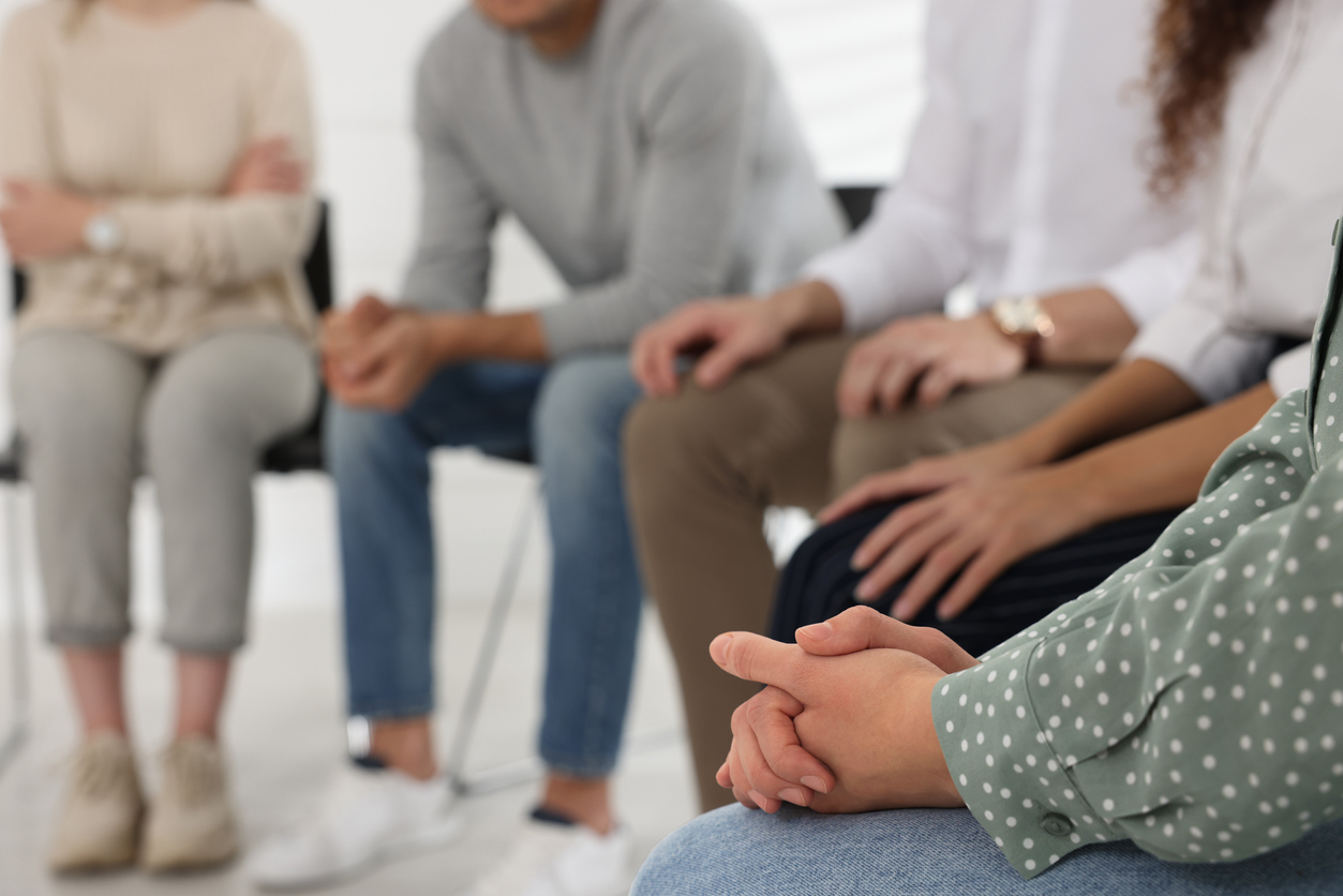 People sitting in circle in a support group