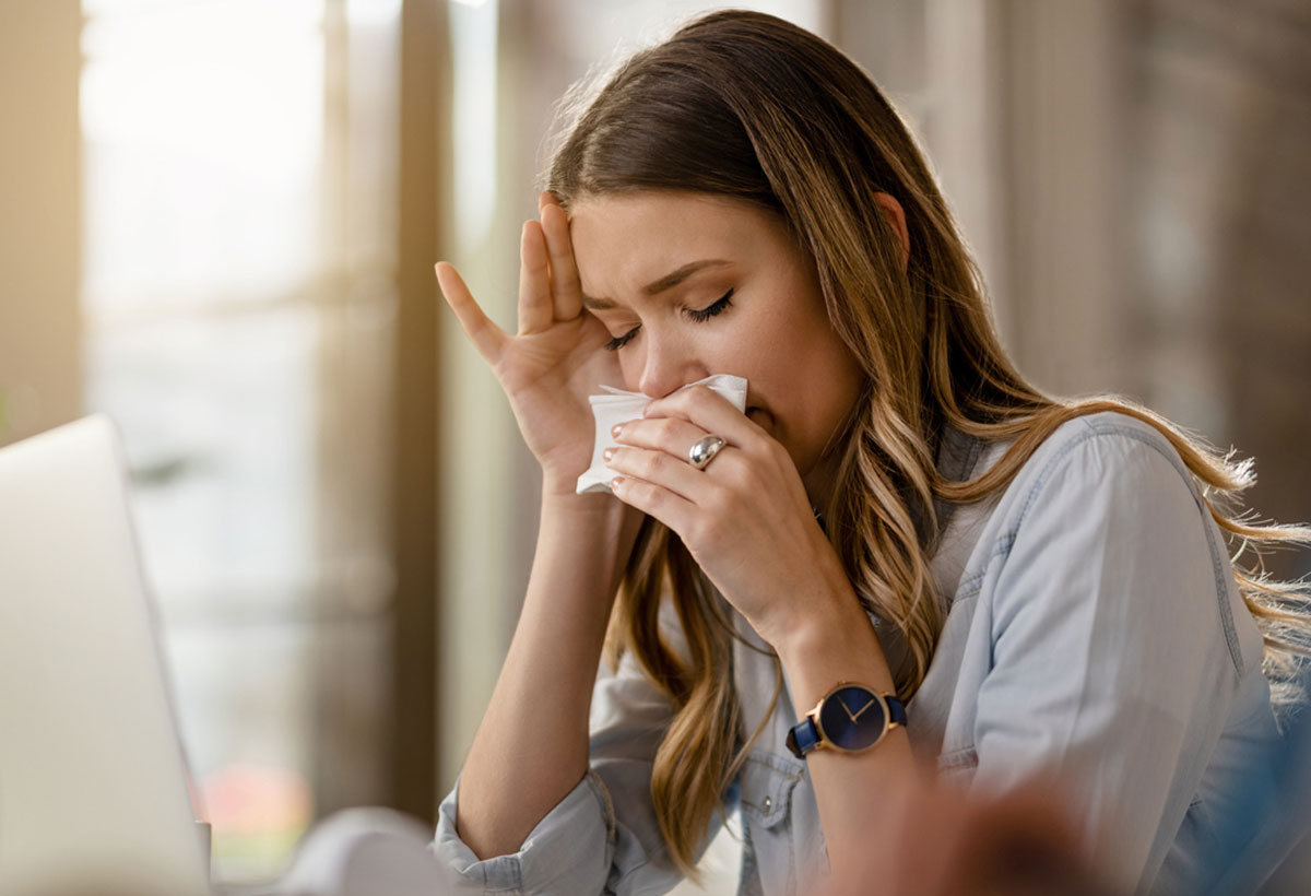 Woman wiping her nose