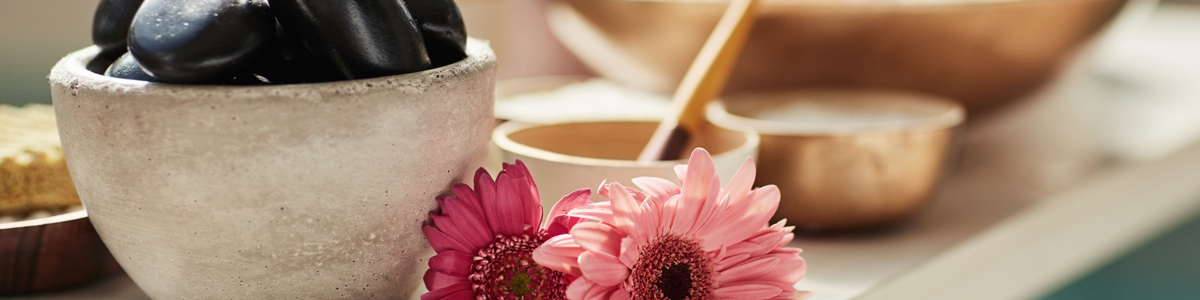 rocks, bowls and flowers on a table