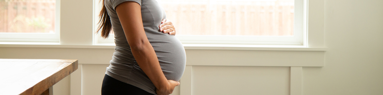 pregnant woman holding belly