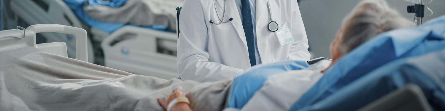 patient in hospital bed being visited by doctor