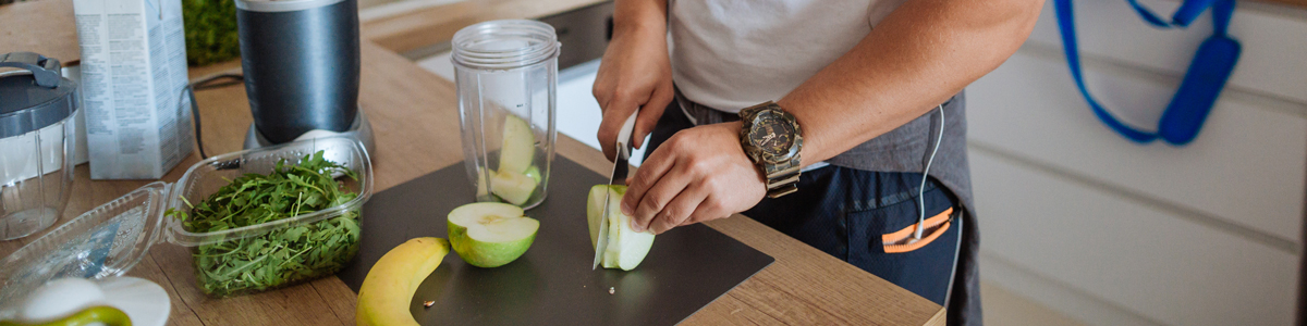 man cutting up apple
