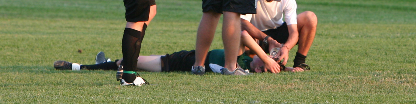 athlete laying on ground after concussion