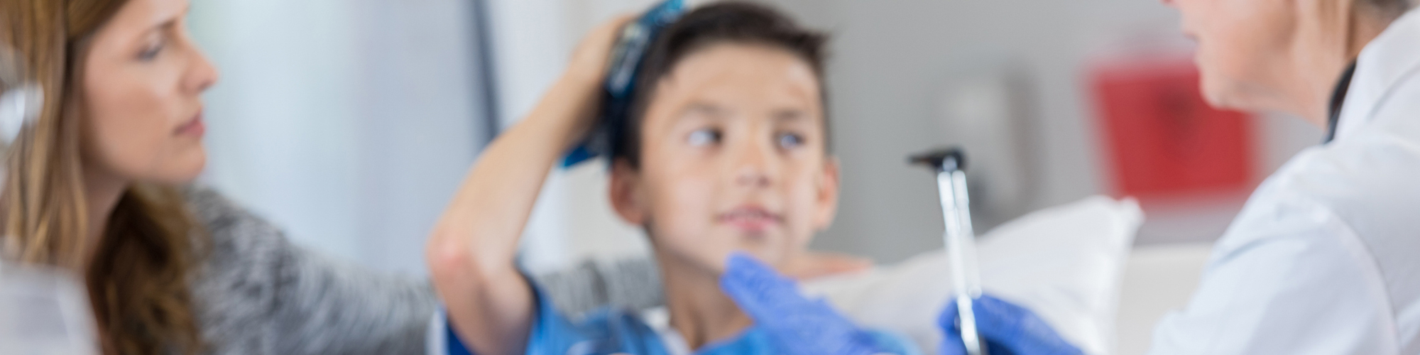 child in hospital room getting examine for concussion