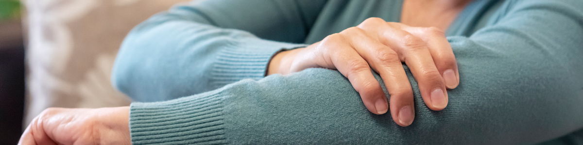 woman holding elbow