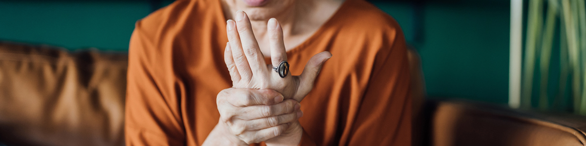 woman holding hurt hand