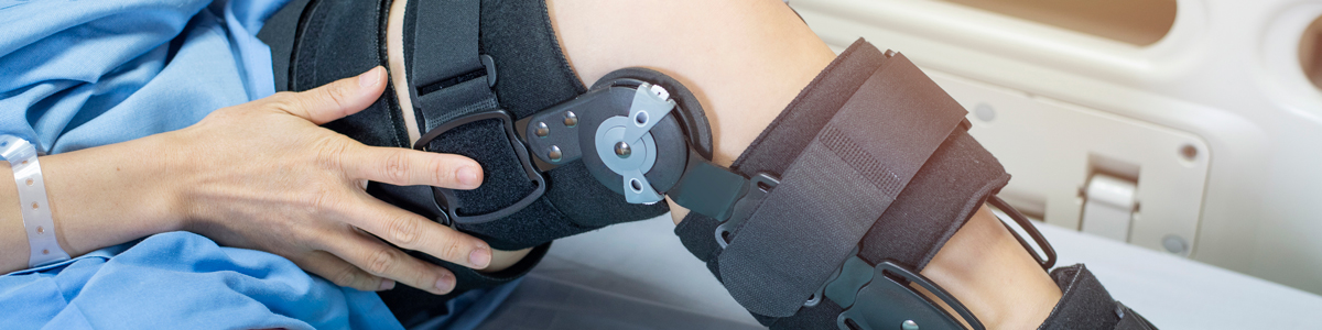 patient in hospital bed with knee brace