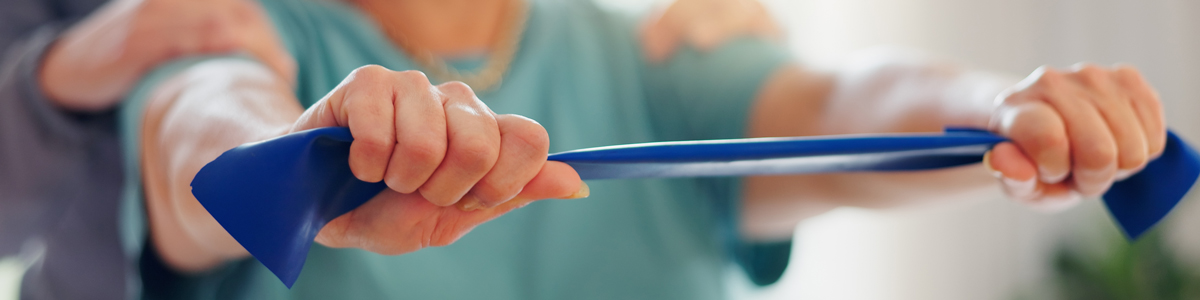 patient using resistance band for stretch