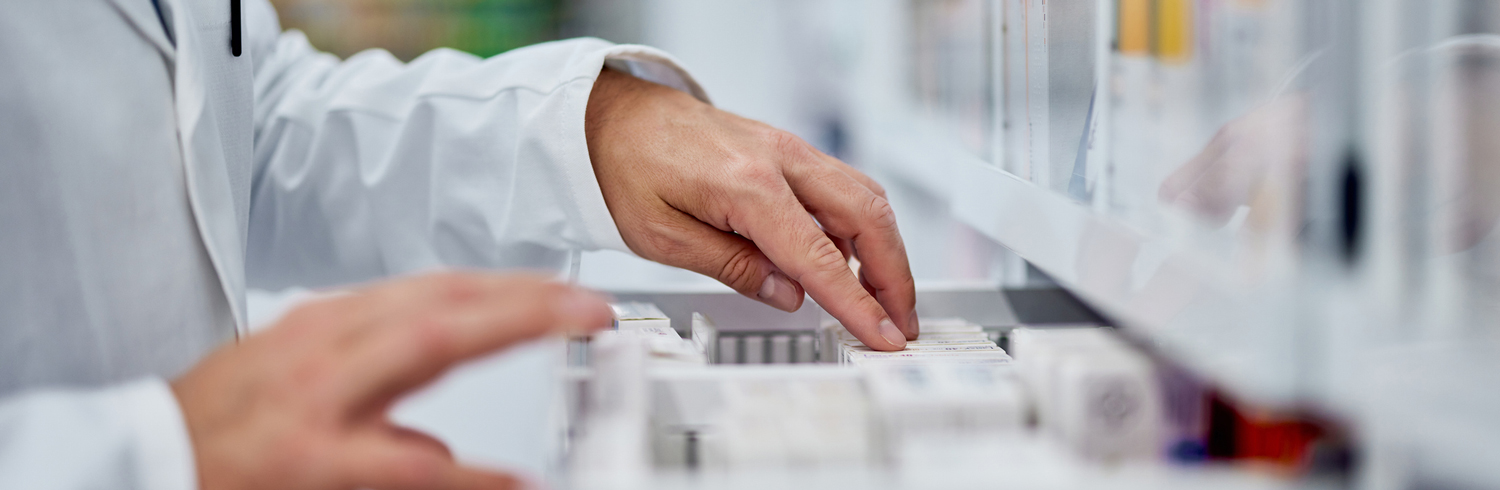 pharmacist sorting through a drawer of medications