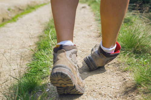 person in hiking boots twisting ankle